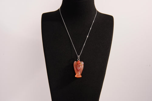 Raw Earth Crystals angel pendant crafted from carved red agate, featuring a warm, translucent design to promote courage, emotional strength, and grounding energy.