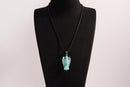 Raw Earth Crystals angel pendant crafted from carved turquoise, featuring a vibrant blue-green hue with natural matrix patterns to promote communication, protection, and emotional balance.