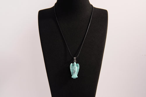 Raw Earth Crystals angel pendant crafted from carved turquoise, featuring a vibrant blue-green hue with natural matrix patterns to promote communication, protection, and emotional balance.