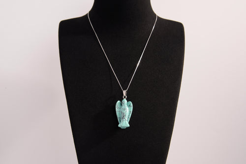 Raw Earth Crystals angel pendant crafted from carved turquoise, featuring a vibrant blue-green hue with natural matrix patterns to promote communication, protection, and emotional balance.