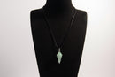 Raw Earth Crystals aventurine pendant with a spiral wire wrap design, crafted from natural stone to enhance luck, prosperity, and emotional balance.