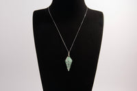 Raw Earth Crystals aventurine pendant with a spiral wire wrap design, crafted from natural stone to enhance luck, prosperity, and emotional balance.