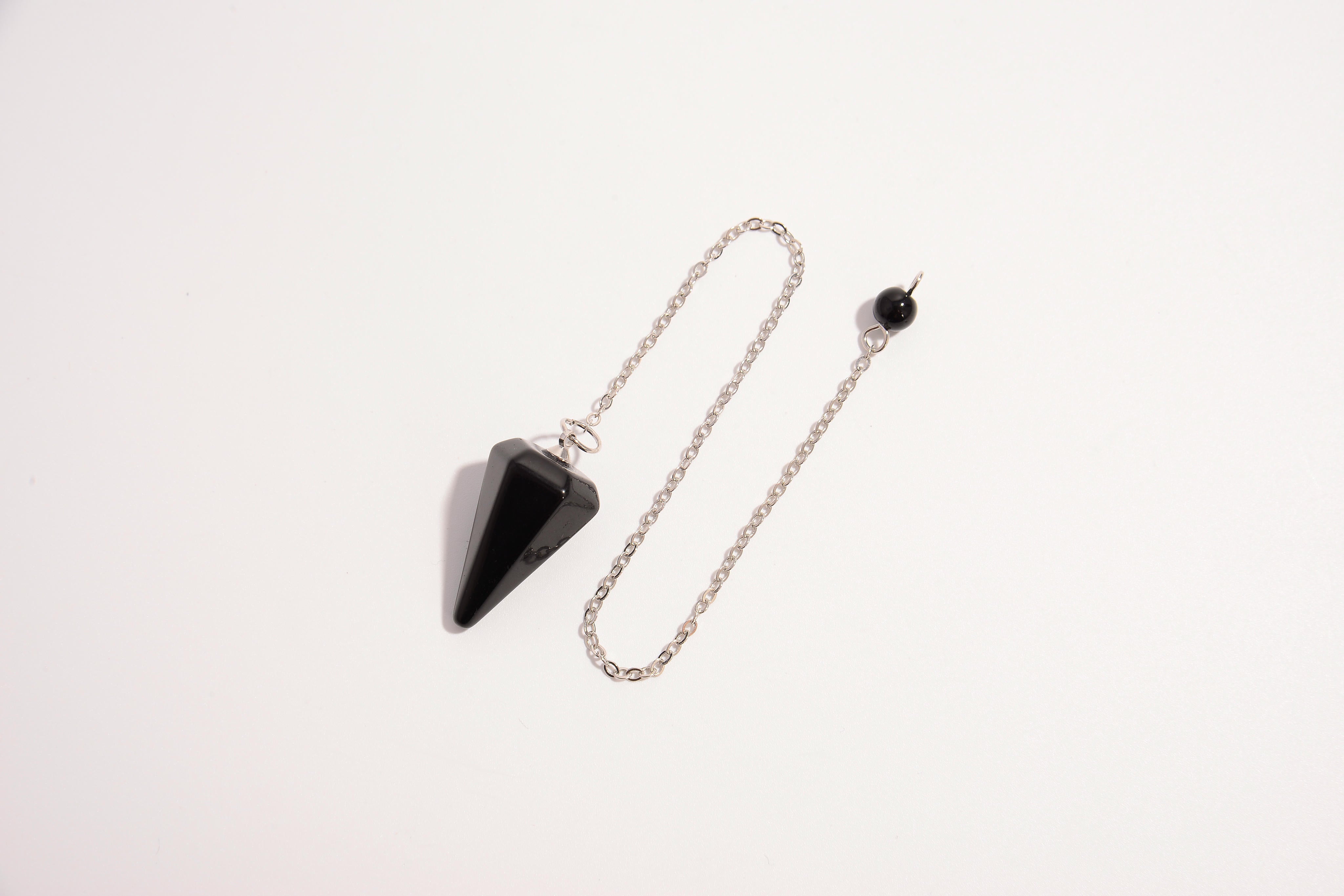 Raw Earth Crystals black obsidian cone pendulum on silver chain, crafted from natural black obsidian stone, promoting protection, grounding, and spiritual clarity.