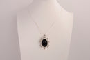 Raw Earth Crystals black obsidian turtle necklace made from natural crystal to offer grounding, protection, and emotional stability.