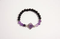 Raw Earth Crystals black onyx and amethyst bracelet with silver accent, crafted from natural crystals, promotes spiritual awareness, calmness, and emotional balance.