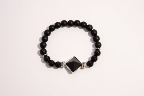 Raw Earth Crystals black onyx and black tourmaline bracelet with silver accent, crafted from natural crystals, promotes protection, grounding, and spiritual clarity.
