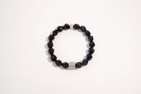 Raw Earth Crystals black onyx and blue goldstone faceted bracelet with silver accent, crafted from natural crystals, promotes protection, confidence, and inner strength.