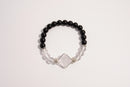 Raw Earth Crystals black onyx and clear quartz bracelet with silver accent, crafted from natural crystals, promotes clarity, protection, and spiritual alignment.