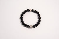 Raw Earth Crystals black onyx faceted bracelet with silver accent, crafted from natural crystal, promotes strength, protection, and emotional balance.