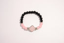 Raw Earth Crystals black onyx and pink quartz bracelet with silver accent, crafted from natural crystals, promotes emotional balance, love, and inner peace.