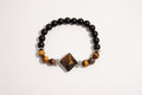 Raw Earth Crystals black onyx and tiger eye bracelet with silver accent, crafted from natural crystals, promotes confidence, protection, and inner strength.