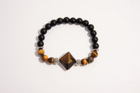 Raw Earth Crystals black onyx and tiger eye bracelet with silver accent, crafted from natural crystals, promotes confidence, protection, and inner strength.