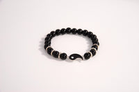 Raw Earth Crystals black tourmaline bracelet with yin yang design, made from natural crystal, supports balance, protection, and spiritual harmony.