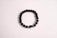Raw Earth Crystals black tourmaline bracelet with yin yang design, crafted from natural crystal, promotes balance, protection, and inner clarity.