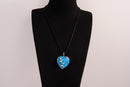 Raw Earth Crystals blue howlite heart pendant with an elegant rose design, featuring a vibrant blue howlite stone and a silver-tone vine with leaves, promoting calmness, emotional stability, and focus.
