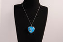 Raw Earth Crystals blue howlite heart pendant with an elegant rose design, featuring a vibrant blue howlite stone and a silver-tone vine with leaves, promoting calmness, emotional stability, and focus.