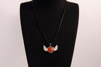 Raw Earth Crystals carnelian heart with wings necklace, featuring a vibrant orange-red heart-shaped stone adorned with delicate angelic wings, designed to boost energy, enhance motivation, and support emotional strength.
