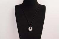 Raw Earth Crystals clear quartz disc pendant necklace featuring a natural crystal for balance, clarity, and spiritual protection.