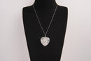 Raw Earth Crystals clear quartz heart pendant with an elegant rose design, featuring a delicate silver-tone stem and leaves embedded in natural clear quartz, promoting clarity, love, and spiritual connection.