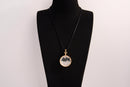 Raw Earth Crystals clear quartz pendant with a crystal-encased design, featuring natural clear quartz and gold-tone setting, enhancing clarity, healing, and spiritual connection.
