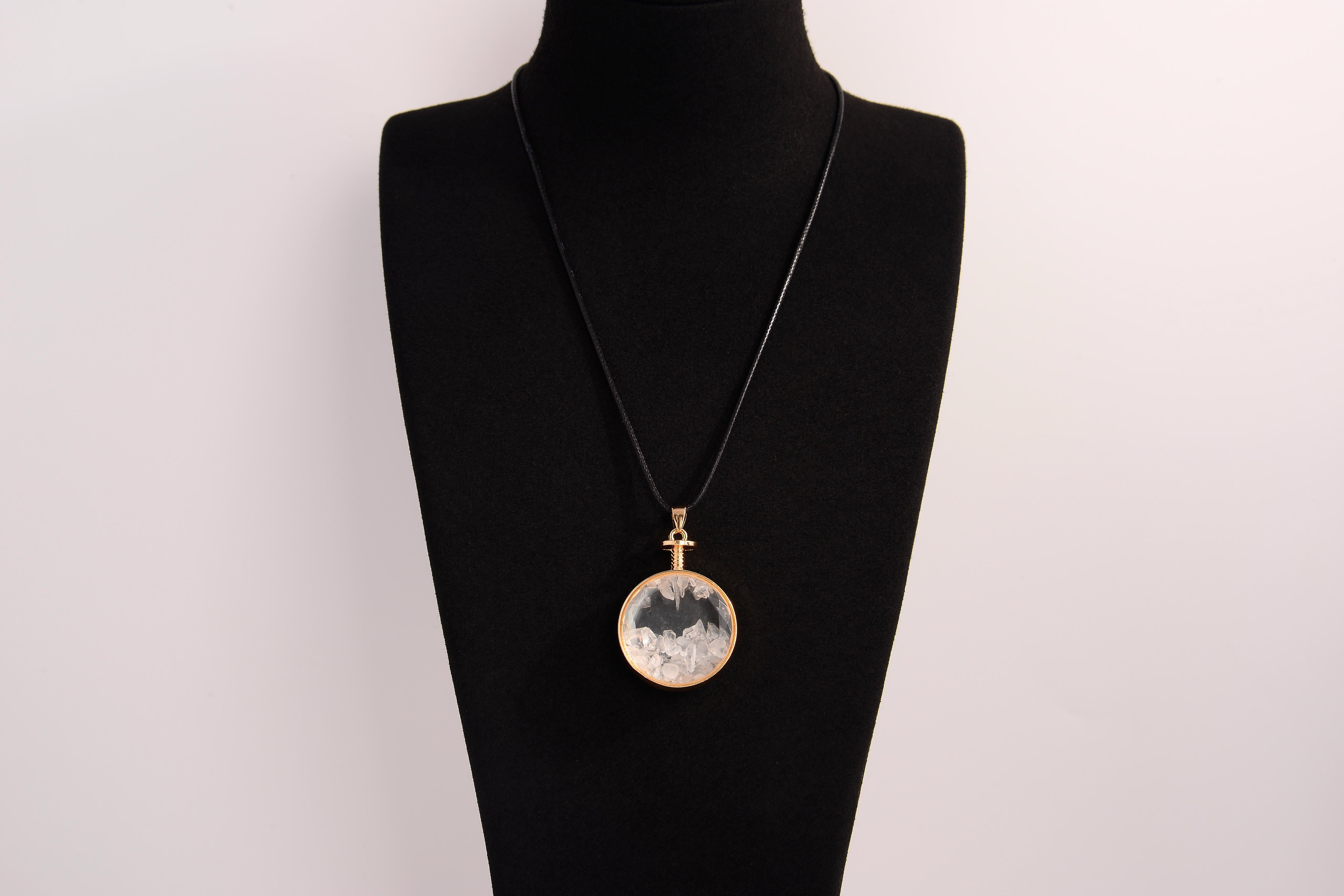 Raw Earth Crystals clear quartz pendant with a crystal-encased design, featuring natural clear quartz and gold-tone setting, enhancing clarity, healing, and spiritual connection.