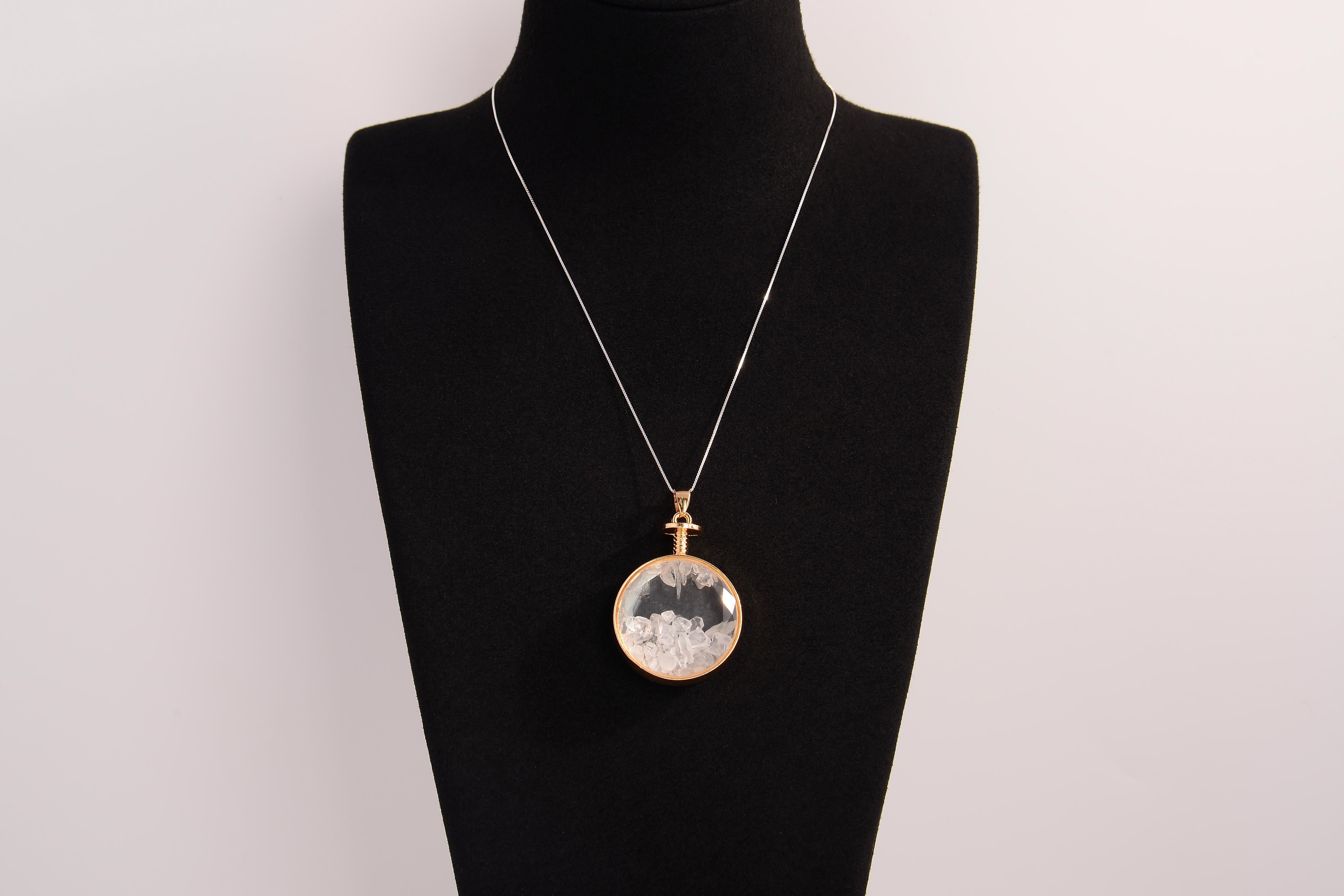 Raw Earth Crystals clear quartz pendant with a crystal-encased design, featuring natural clear quartz and gold-tone setting, enhancing clarity, healing, and spiritual connection.