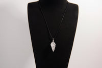 Raw Earth Crystals clear quartz pendant with a spiral wire wrap design, crafted from natural stone to enhance clarity, focus, and spiritual energy.