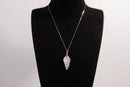 Raw Earth Crystals clear quartz pendant with a spiral wire wrap design, crafted from natural stone to enhance clarity, focus, and spiritual energy.