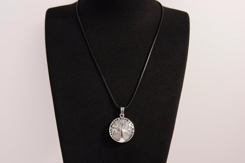 Raw Earth Crystals clear quartz pendant featuring a tree of life design, crafted with natural crystal for clarity, energy amplification, and balance.