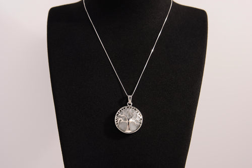 Raw Earth Crystals clear quartz pendant featuring a tree of life design, crafted with natural crystal for clarity, energy amplification, and balance.