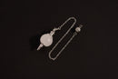 Raw Earth Crystals clear quartz pendulum with silver chain, crafted from natural crystal, promotes clarity, healing, and spiritual insight.