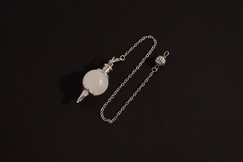 Raw Earth Crystals clear quartz pendulum with silver chain, crafted from natural crystal, promotes clarity, healing, and spiritual insight.