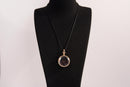 Raw Earth Crystals garnet pendant with a crystal-encased design, featuring natural garnet and gold-tone setting, promoting passion, vitality, and emotional strength.