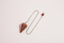 Raw Earth Crystals golden quartz pendulum with pointed crystal and silver chain, designed for manifestation, abundance, and energetic clarity.