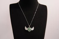 Raw Earth Crystals green aventurine heart with wings necklace, featuring a vibrant green heart-shaped stone adorned with delicate angelic wings, designed to promote abundance, emotional balance, and spiritual growth.