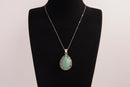 Raw Earth Crystals green aventurine pendant with a teardrop-shaped design, featuring natural green aventurine and an ornate silver-tone setting, promoting prosperity, luck, and emotional balance.