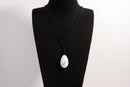 Raw Earth Crystals howlite teardrop pendant on black cord, crafted from natural howlite stone, promoting calmness, patience, and emotional balance.