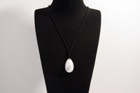 Raw Earth Crystals howlite teardrop pendant on black cord, crafted from natural howlite stone, promoting calmness, patience, and emotional balance.