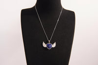 Raw Earth Crystals lapis lazuli heart with wings necklace, featuring a deep blue heart-shaped stone adorned with delicate angelic wings, designed to enhance wisdom, promote self-expression, and support spiritual insight.