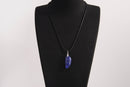 Raw Earth Crystals lapis lazuli pendant featuring an etched design, crafted from natural stone to promote truth, inner wisdom, and spiritual connection.