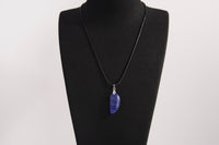 Raw Earth Crystals lapis lazuli pendant featuring an etched design, crafted from natural stone to promote truth, inner wisdom, and spiritual connection.
