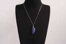 Raw Earth Crystals lapis lazuli pendant featuring an etched design, crafted from natural stone to promote truth, inner wisdom, and spiritual connection.