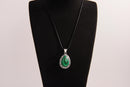 Raw Earth Crystals malachite pendant with a teardrop-shaped design, featuring natural malachite and an ornate silver-tone setting, promoting transformation, abundance, and emotional healing.