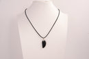 Raw Earth Crystals obsidian angel wing pendant, featuring a polished black obsidian stone carved into an elegant wing shape and set on a silver-tone chain, promoting protection, grounding, and spiritual connection.