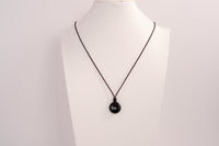 Raw Earth Crystals obsidian disc pendant necklace crafted from natural crystal for protection, grounding, and spiritual clarity.