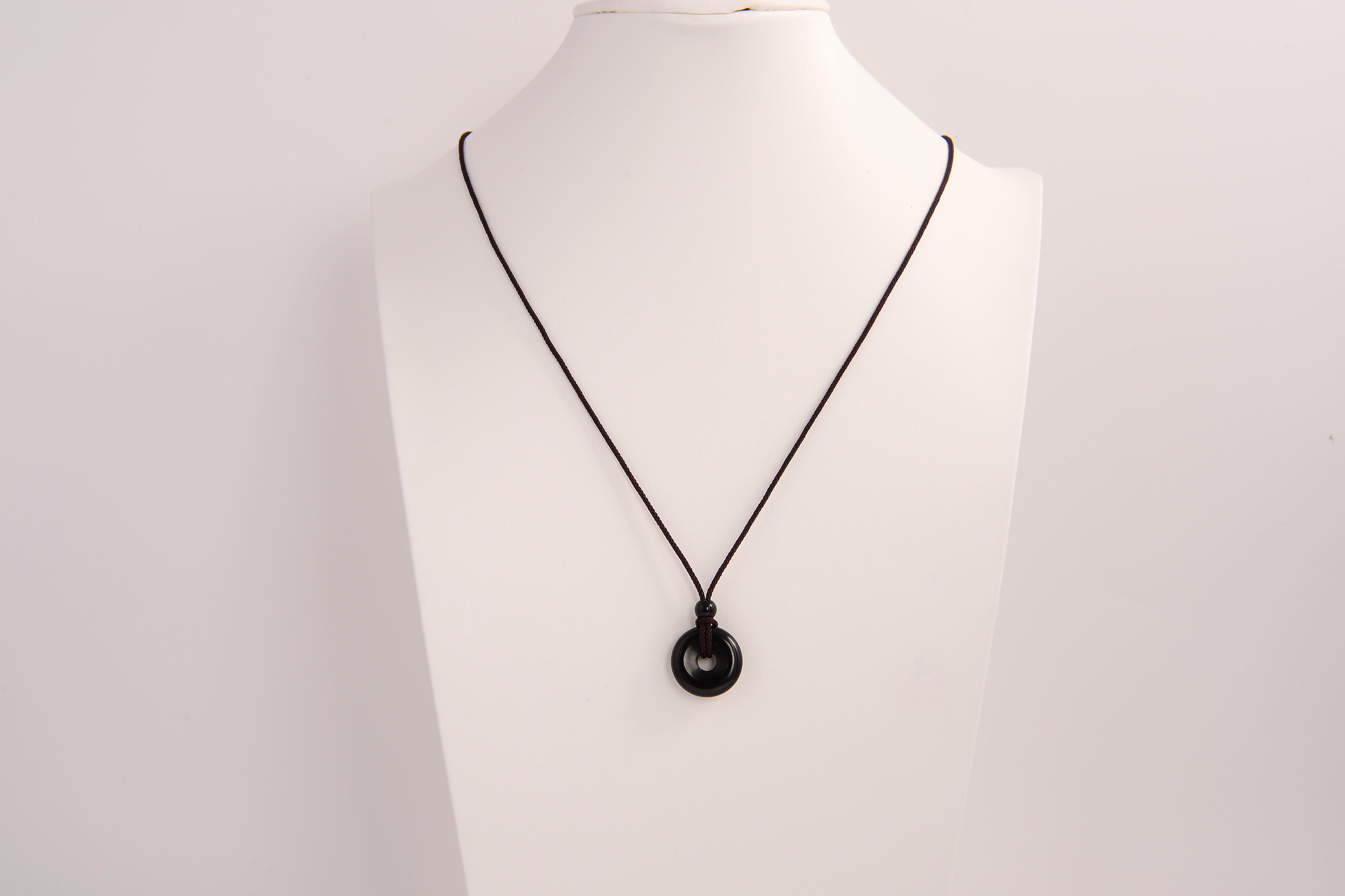 Raw Earth Crystals obsidian disc pendant necklace crafted from natural crystal for protection, grounding, and spiritual clarity.