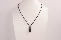 Raw Earth Crystals obsidian necklace with a pointed natural stone pendant, designed to offer protection, grounding, and emotional clarity.