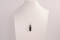 Raw Earth Crystals obsidian necklace with a pointed natural stone pendant, designed to offer protection, grounding, and emotional clarity.