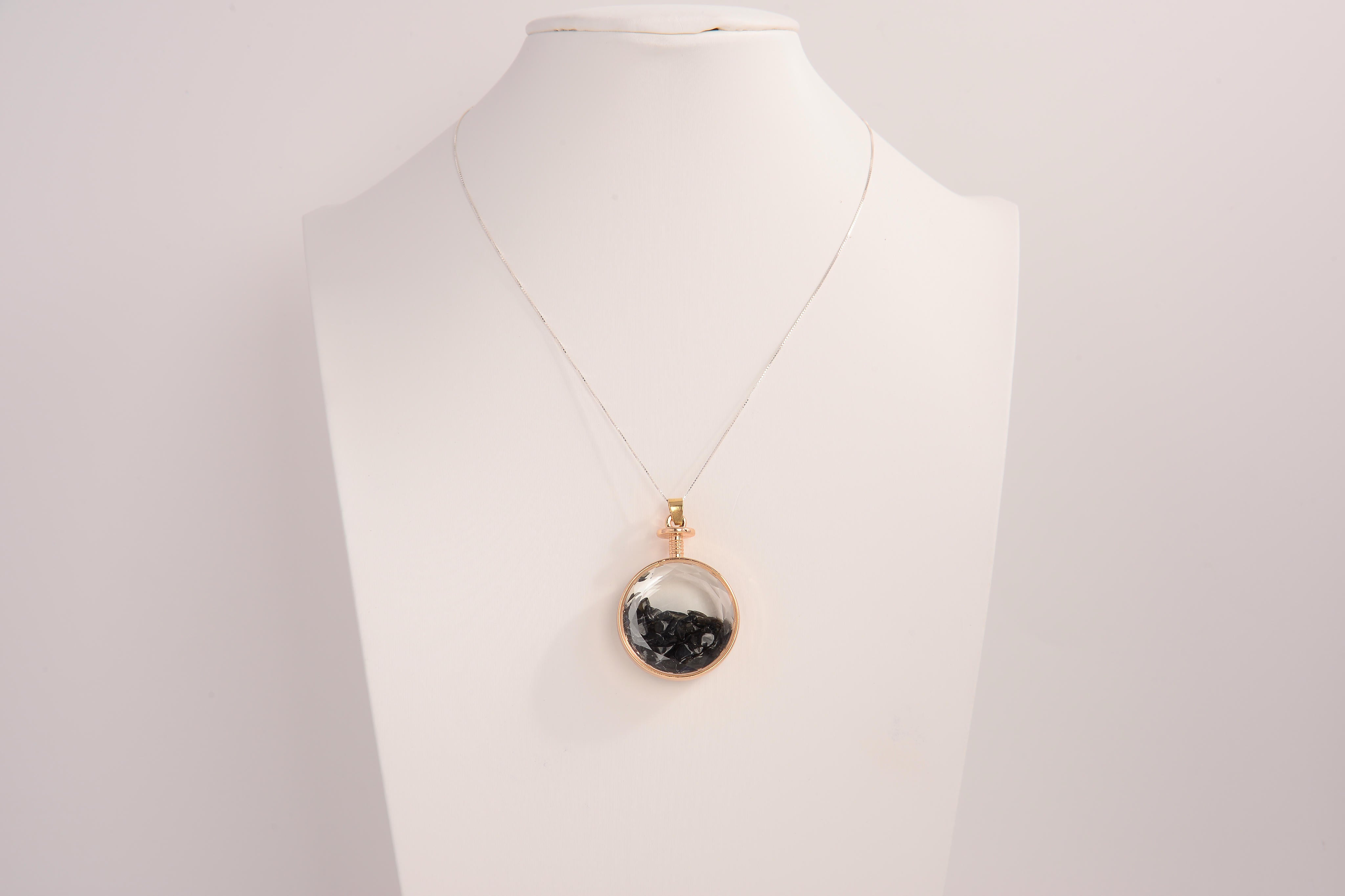 Raw Earth Crystals obsidian pendant with a crystal-encased design, featuring natural obsidian and gold-tone setting, promoting protection, grounding, and emotional balance.