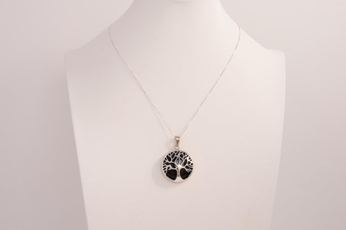 Raw Earth Crystals obsidian pendant featuring a tree of life design, crafted with natural black obsidian and sterling silver, promoting grounding, protection, and spiritual clarity.